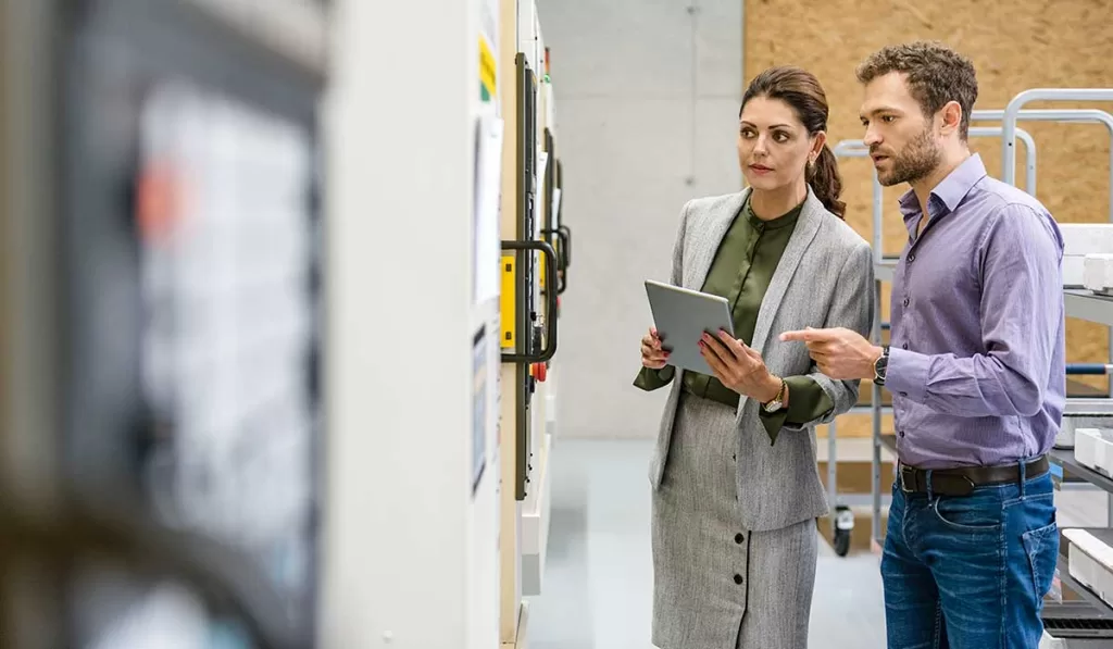Internal Audit Ultimate Guide: Basic Practices to Future Trends 6 businessman-and-woman-having-a-meeting-in-high-tech-manufacturing-internal-control-financial-audit