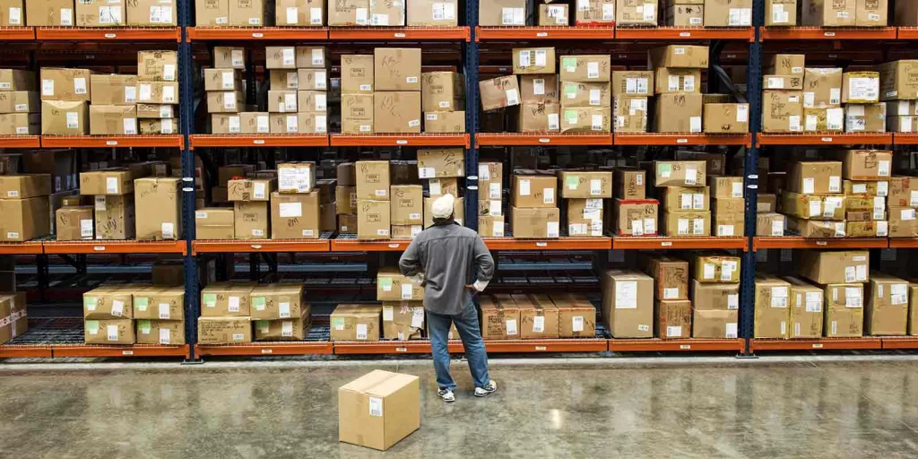 Mastering ERP Systems: The Ultimate Handbook 3 warehouse-worker-checking-inventory-next-to-large-rack-manually-instead-of-efficient-erp-models